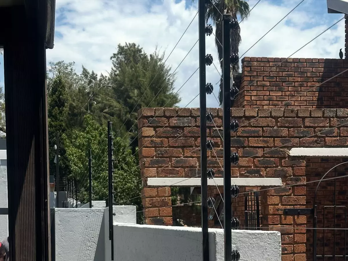 Electric security fence on a brick wall