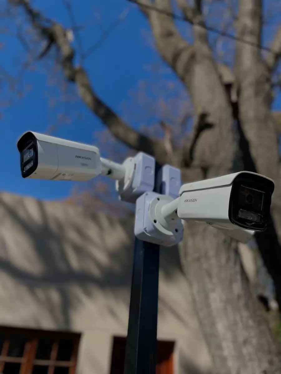 Two Hikvision security cameras mounted on a pole